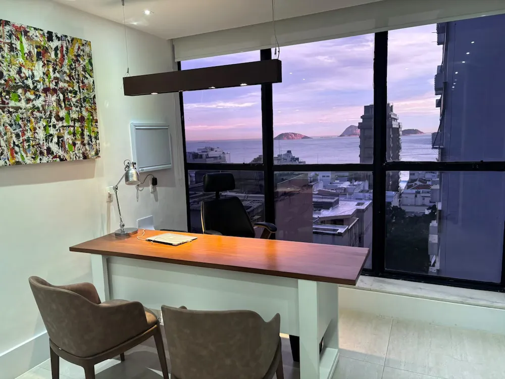 Vista da sala de atendimento do consultório com janela para a cidade